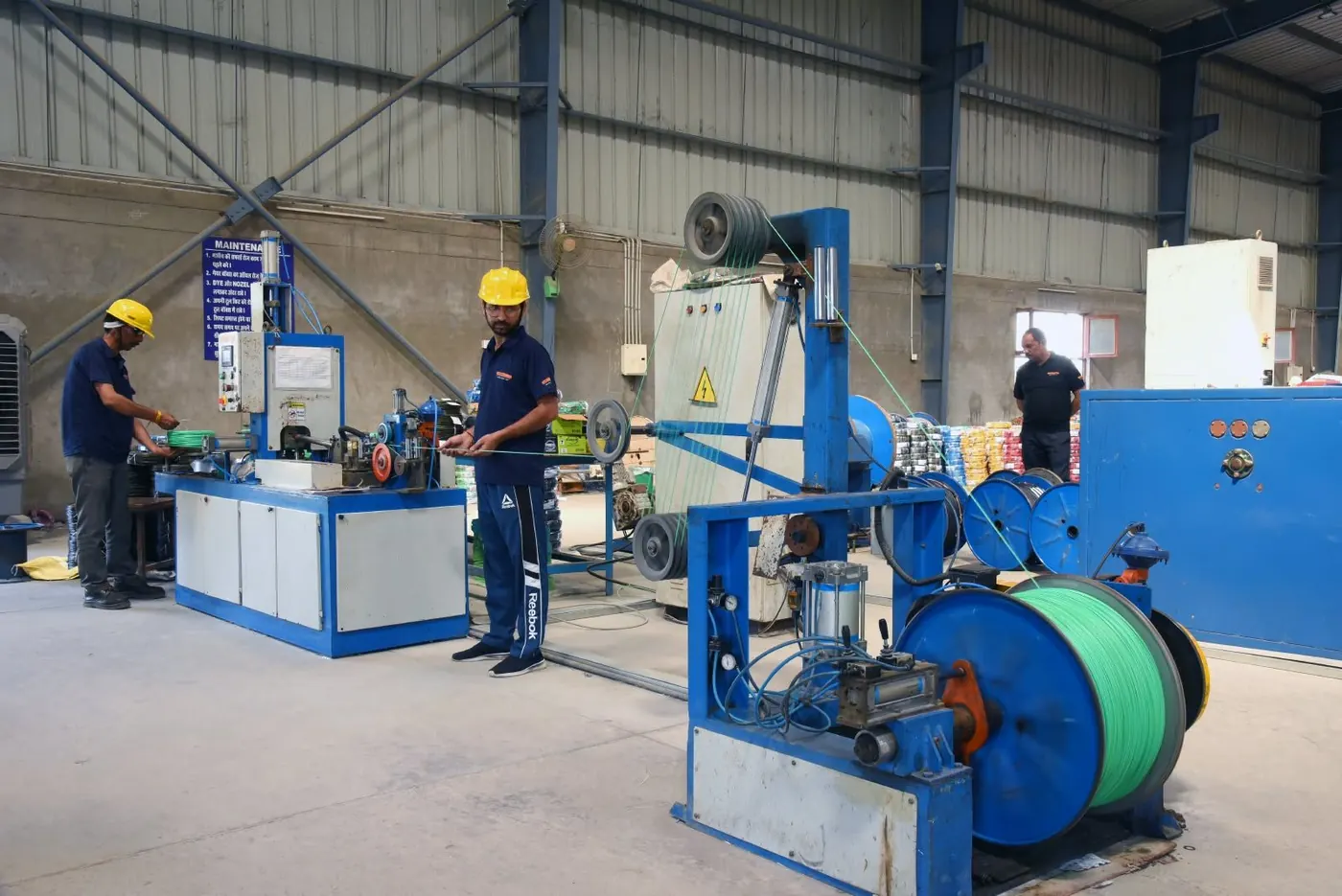 Batra Henlay Cables coiling line with finished green wire on a drum