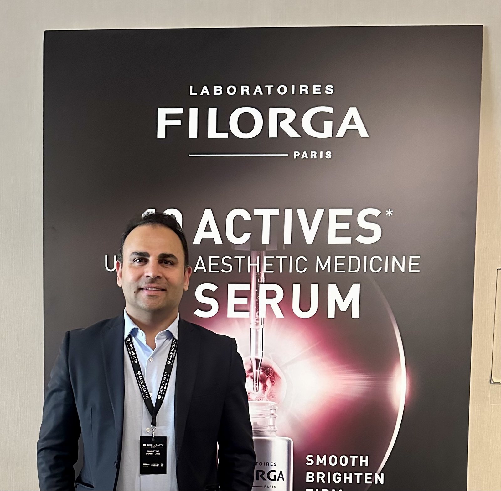 Raj Sandhan in front of a Laboratoires Filorga display for the brand's actives serum